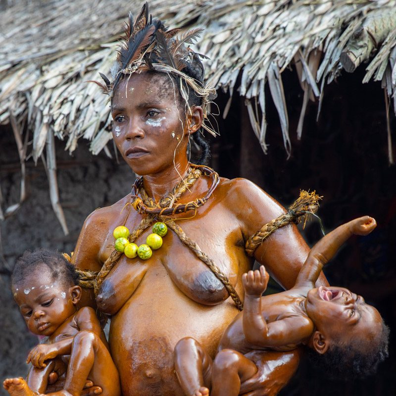 ngombe wale woman with her sons during ritual on ethnographic trip to D. R. Congo